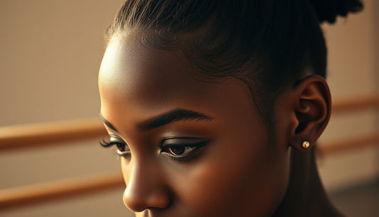 Black ballet dancer's thinning temples with hair pulled tightly back at a barre