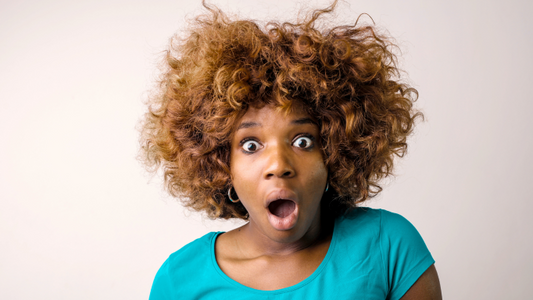 African american woman looking shocked with dry hair