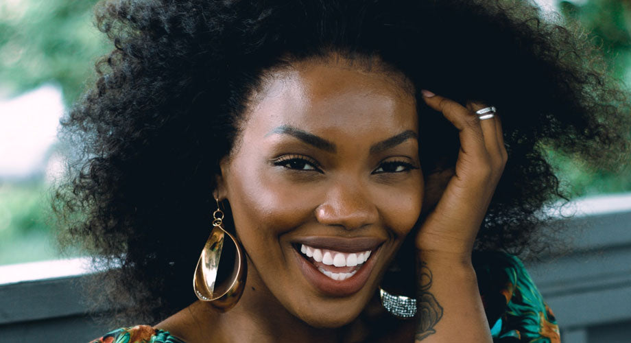 Woman smiling with black curly hair
