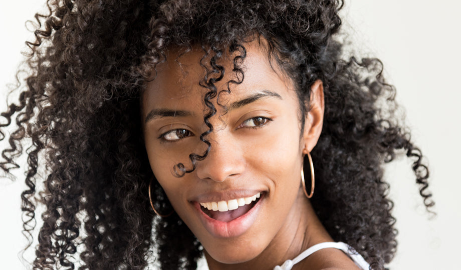 Woman smiling with healthy curly hair